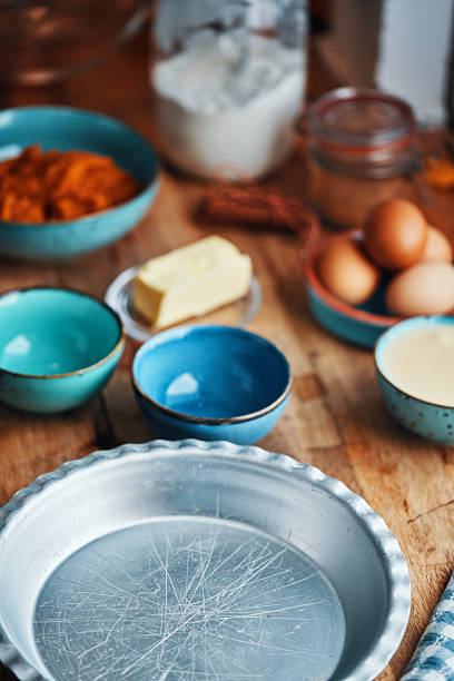 Preparing Pumpkin Pie for the Holidays in Domestic Kitchen