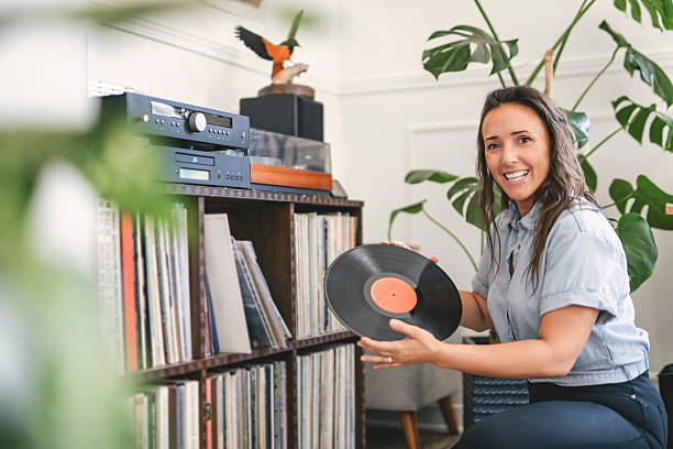 istock young woman putting on a vinyl record at home 2243627998