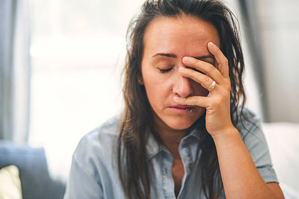 istock young woman with feeling sad and stressed, sick and headache 2243628131