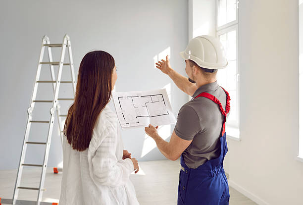 istock Builder and woman discussing renovation process in apartment 2243631528