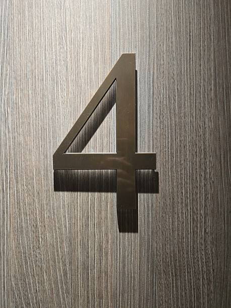 Silver number four on wooden background
