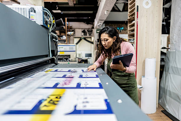 istock Mid adult woman analyzing digital prints using tablet in printing workshop 2243642173