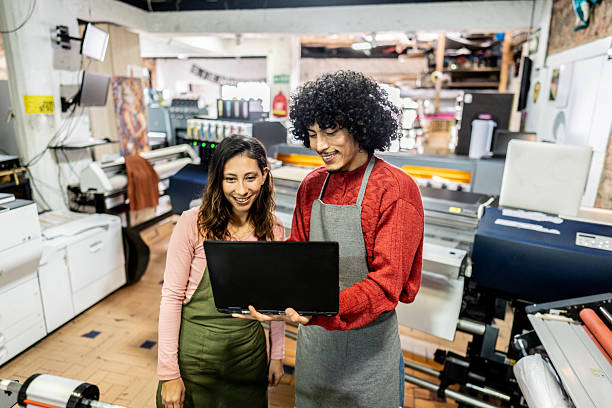 istock Coworkers collaborating on digital printing machine operation 2243642342