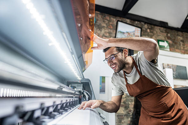 istock Technician examining digital printing machine in print shop 2243642507