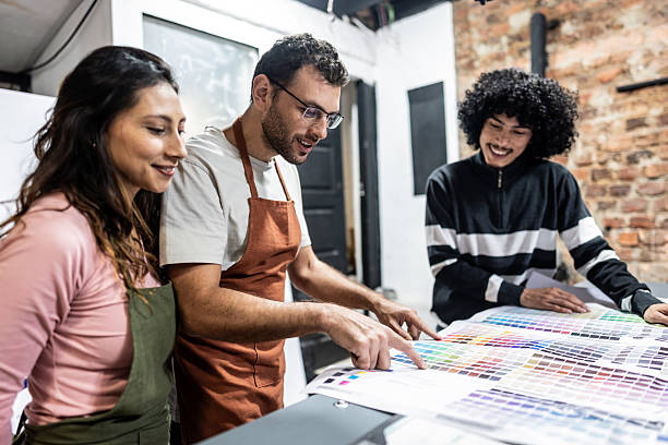 istock Digital printing office colleagues reviewing printed materials and color samples 2243642552
