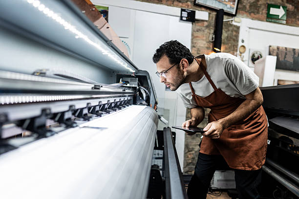 istock Technician examining digital printing machine in print shop 2243642557