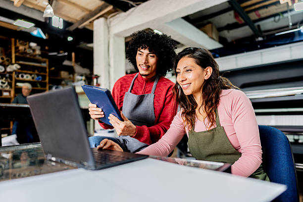 istock Modern workplace teamwork with laptop and tablet in printing facility 2243642580