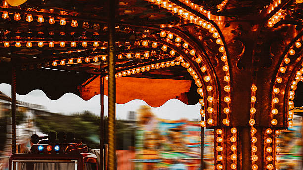 istock Spinning Carousel Ride with Motion Blur and Warm Lights – Night Fairground Scene 2243646661