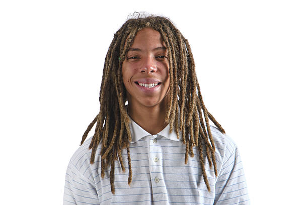 Young man with dreadlocks smiling, wearing a striped polo shirt on a white background
