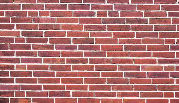 istock Brown and red brick wall background texture with white mortar lines. 2243659392
