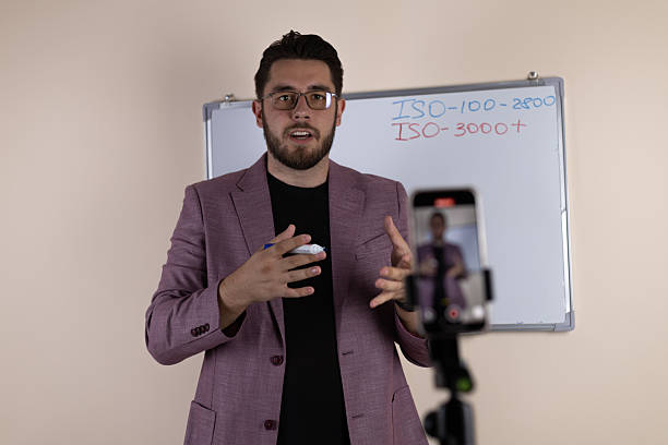istock The man is recording a podcast episode in a studio setting, standing in front 2243660492