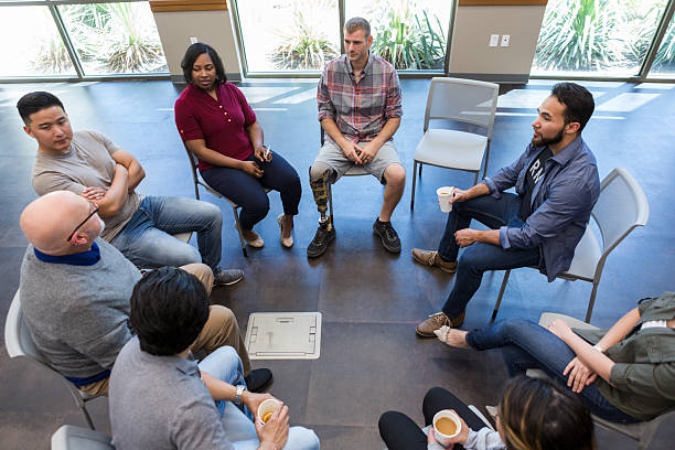 istock Diverse group engaged in a supportive discussion circle, fostering connection and shared experience. 2243660495