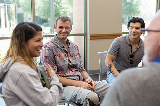 istock Diverse group of adults engaged in a supportive conversation during a meeting. 2243660501