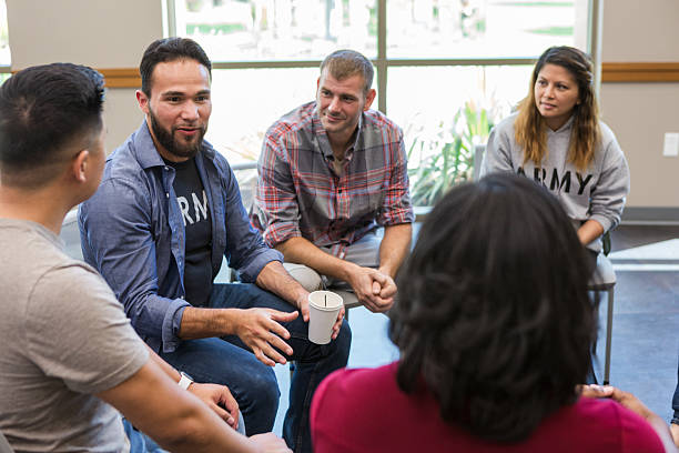 istock Diverse adults engaged in a group discussion session indoors, fostering connection. 2243660506