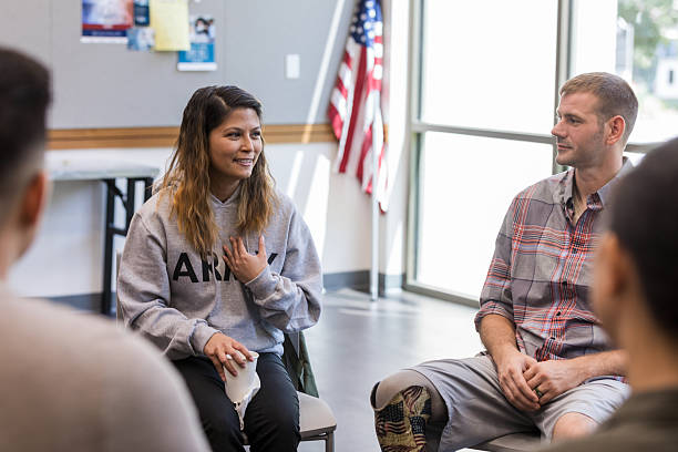 istock Group discusses challenges and offers emotional support while listening intently to each other. 2243660545