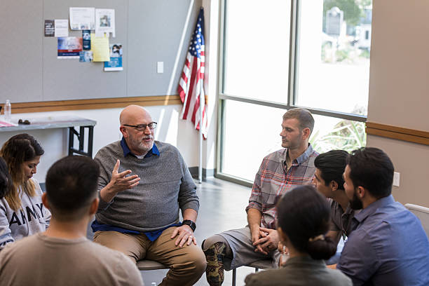 istock Veterans in group therapy discussing challenges and offering support to one another. 2243660560