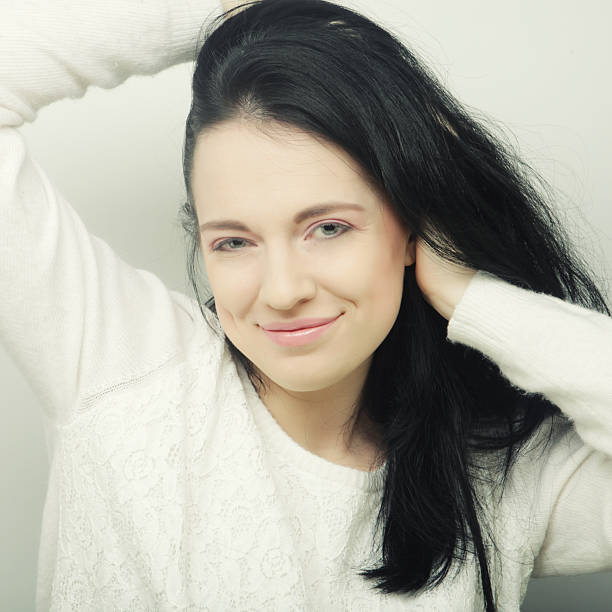 Beautiful young happy brunette woman. Studio shot.
