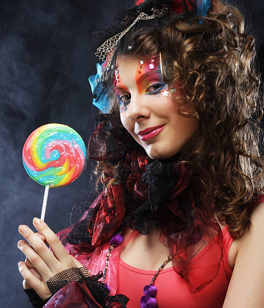 istock woman with creative make-up in doll style with candy. 2243661212