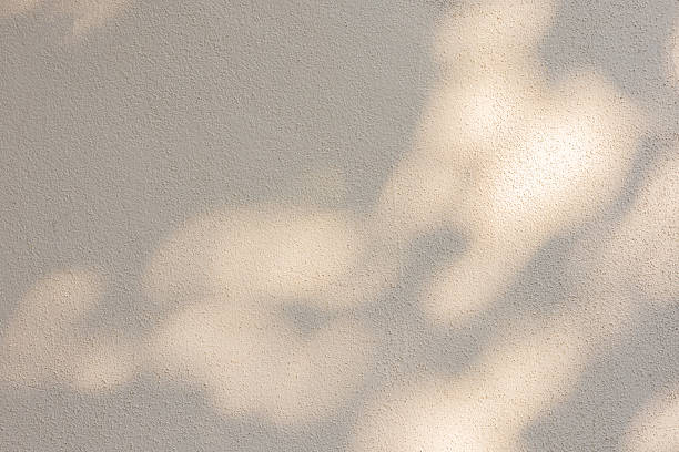 istock close up on beige plain wall background texture with shadow of window from sunlight for ads and advertisement product such as cosmetic or content or goods design display concept 2243662534
