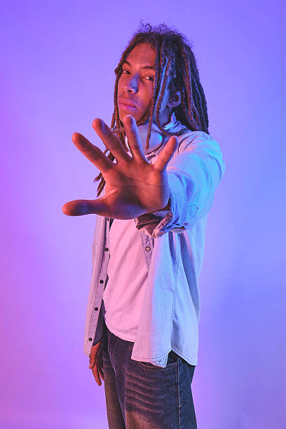 istock Black man gesturing stop with hand in neon light 2243662544