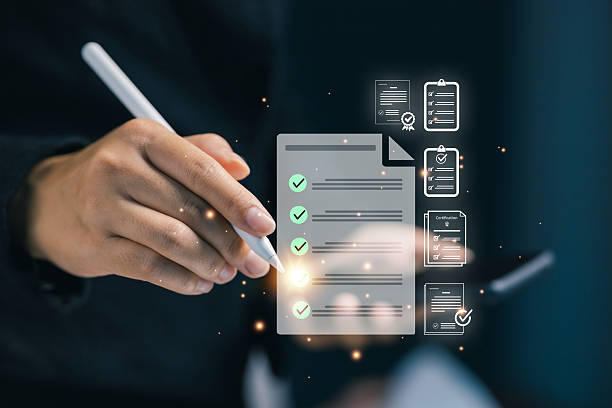 istock Hand using stylus to mark digital checklist and document icons on virtual screen. Concept of online document management, certification, and digital productivity workflow. 2243663455