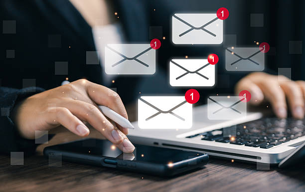 istock Hand using a digital pen with smartphone and laptop showing multiple new email notifications. Concept of online communication, inbox alert, digital marketing, and business connection. 2243663902