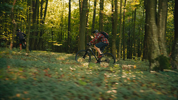 istock Dynamic Caucasian Male Cyclists Navigating Sunlit Forest Trail with Enthusiasm 2243665336