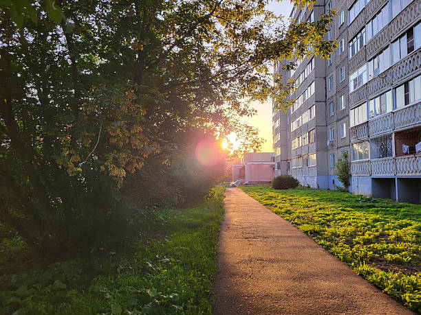 istock At sunset, when the sunlight flickers through the trees and city buildings 2243667475