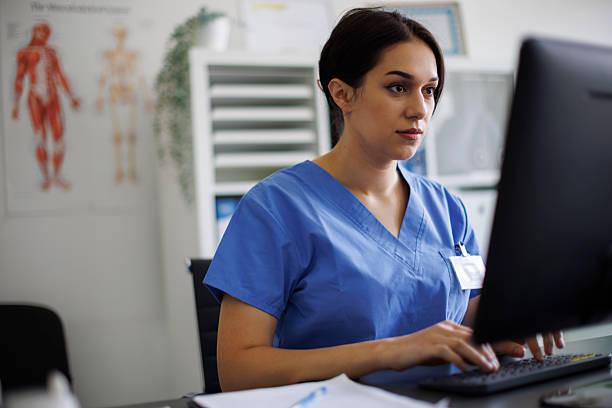 istock Focused nurse working on computer at medical office 2243668603