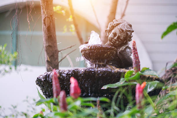 Beautiful garden structure featuring a charming cherub statue with flowing water, creating a serene atmosphere that enhances outdoor relaxation and decoration.