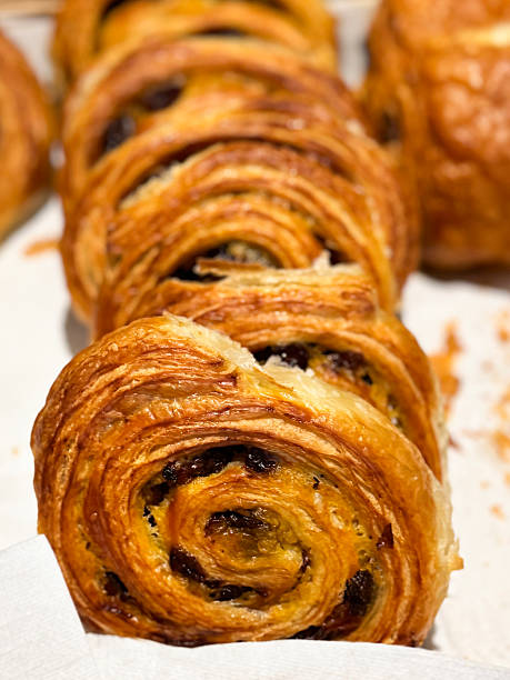 Image of golden croissants and breakfast pastries / freshly baked bakery selection, flaky morning treats, artisan pastries