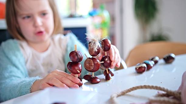 istock Happy Creative Caucasian Kids Playing with Chestnut Figurines at Kindergarten 2243673424