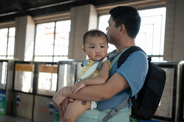 istock Man and child waiting for subway 2243674583