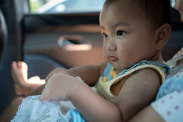 Baby riding in the car, looking ahead