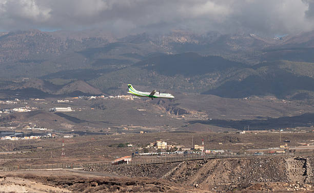A Binter Canarias ATR 72-600 gracefully climbs away from Tenerife South Airport, set against the rugged volcanic slopes and lush pine forests of the island’s interior. The aircraft’s green-and-white livery stands out sharply against the earthy tones of the Canarian landscape, illuminated by a break in the clouds. The photo captures the essence of inter-island travel in the Canary Islands — connecting remote volcanic peaks with moments of flight and light.