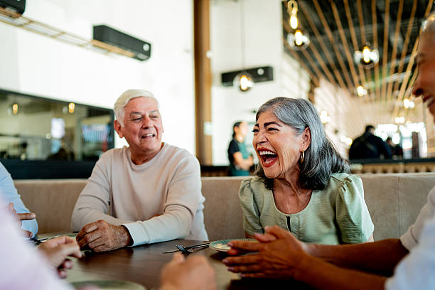 istock Senior friends talking during dinner at restaurant 2243680224