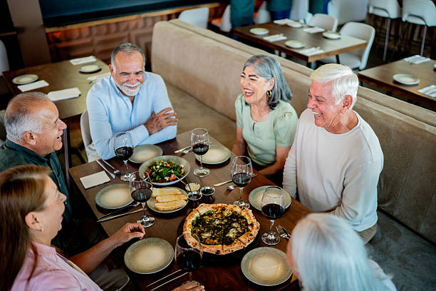 istock Senior friends talking during dinner at restaurant 2243680933