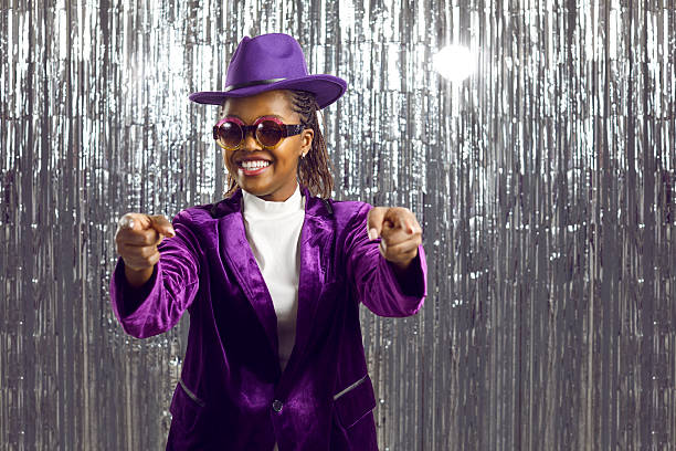 istock Smiling black woman entertainer point at screen 2243681078