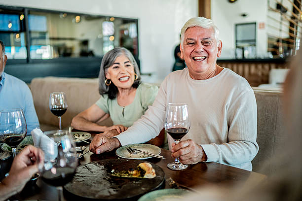 istock Senior friends talking during dinner on restaurant 2243681123