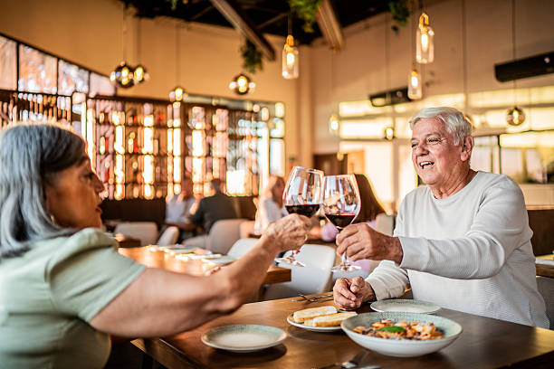istock Senior couple toasting wine at restaurant 2243682670