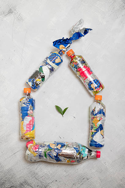 Image of crates with water bottles, cardboard crates and items for recycling.