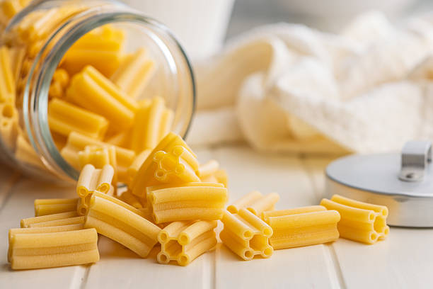 istock Cinque buchi. Uncooked italian pasta in jar on white table. 2243684024
