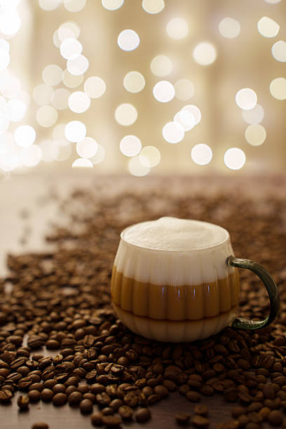 istock elegant coffee cup surrounded by roasted beans with soft bokeh lights creating a warm and cozy ambiance on a wooden surface, enjoy, detail, craft, artistic, luxury, appearance, serene, refreshing 2243687310