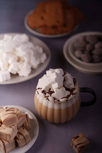 istock a cozy assortment featuring frothy hot chocolate with star-shaped marshmallows, a rich display of caramel sweets, and plates of cookies, creating a warm, indulgent ambiance, photography, artistic 2243687422