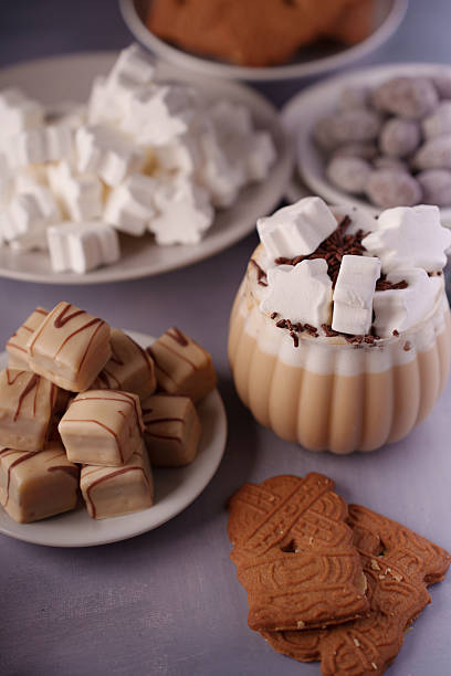 istock assorted sweet treats arrangement with marshmallow-adorned beverage and assorted confections on ceramic plates in cozy setting, decadent, elegant, luxurious, warming, cozy, evening, festive 2243687435
