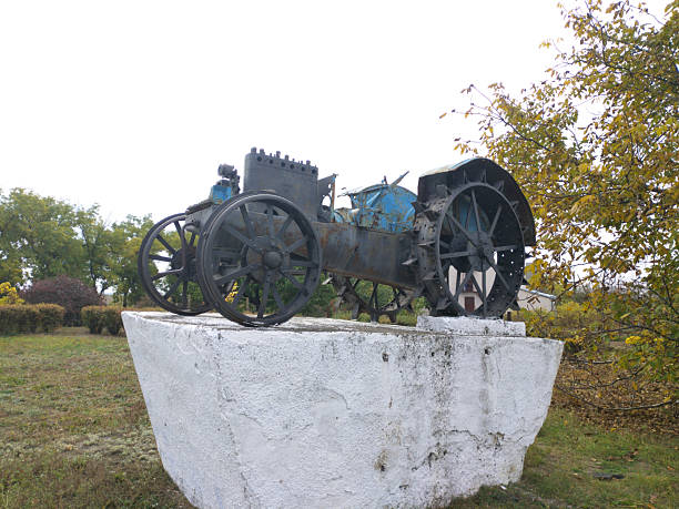 Tiraspol, Moldova - October 15, 2021: Monument to the first tractor and its drivers. Agricultural machinery. Industrialization and mechanization of labor.