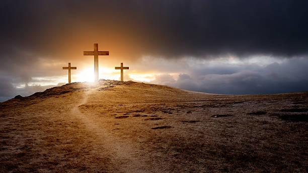 istock Path toward Christian cross on the hill with dark dramatic sky background. Concept of Christianity, religious, faith, Jesus, or belief 2243688904
