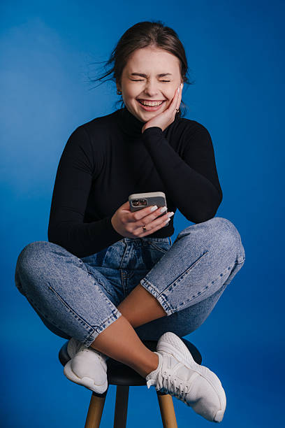 istock female learner relaxing outdoors happily, woman enjoying leisure time with her electronic device 2243689411