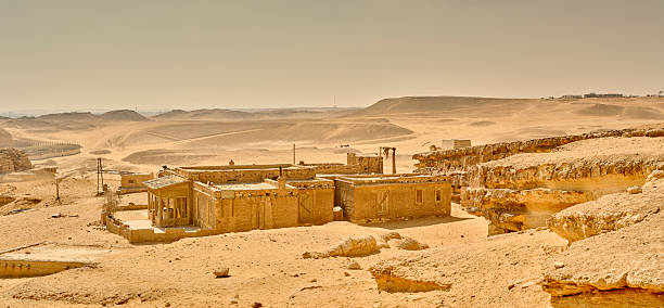 Kerma, Sudan - April 28, 2010: The oasis of Kerma village, next to the dilapidated ruins of Kerma (also known as Dukki Gel), a 5500 years old civilization that flourished in the Nubian desert, in northern Sudan. Kerma is one of the largest archaeological sites in ancient Nubia, most of it abandoned and at the mercy of the elements and birds nesting on its walls. The Nubian Desert is in the eastern region of the Sahara Desert, between the Nile and the Red Sea. The native inhabitants of the area are the Nubians, descendants of the ancient Nubian civilizations.