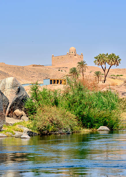 istock Historic stone structure overlooking lush greenery along the Nile River under a clear blue sky 2243694492